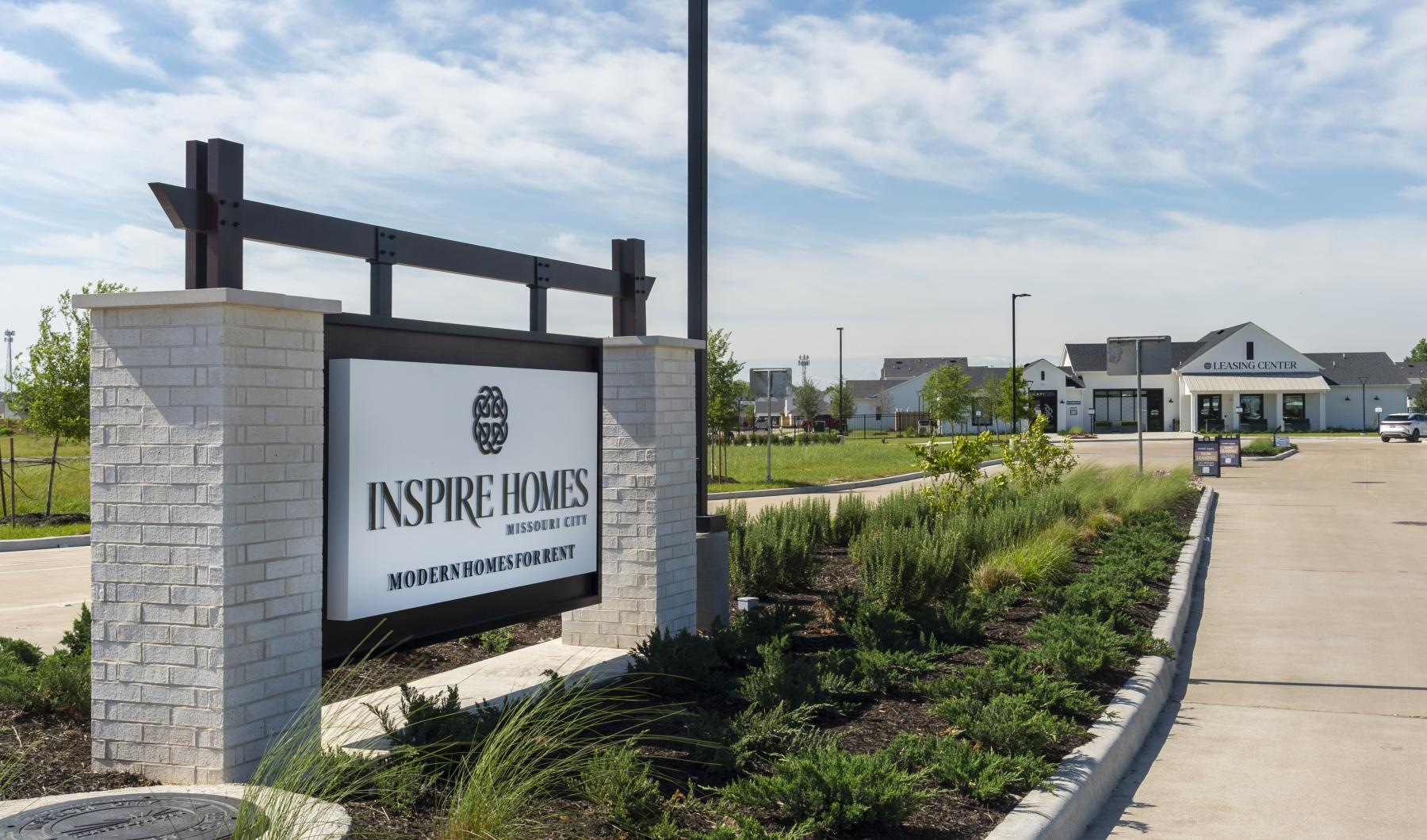 Settle into comfort at Inspire Missouri City a sign on a fence