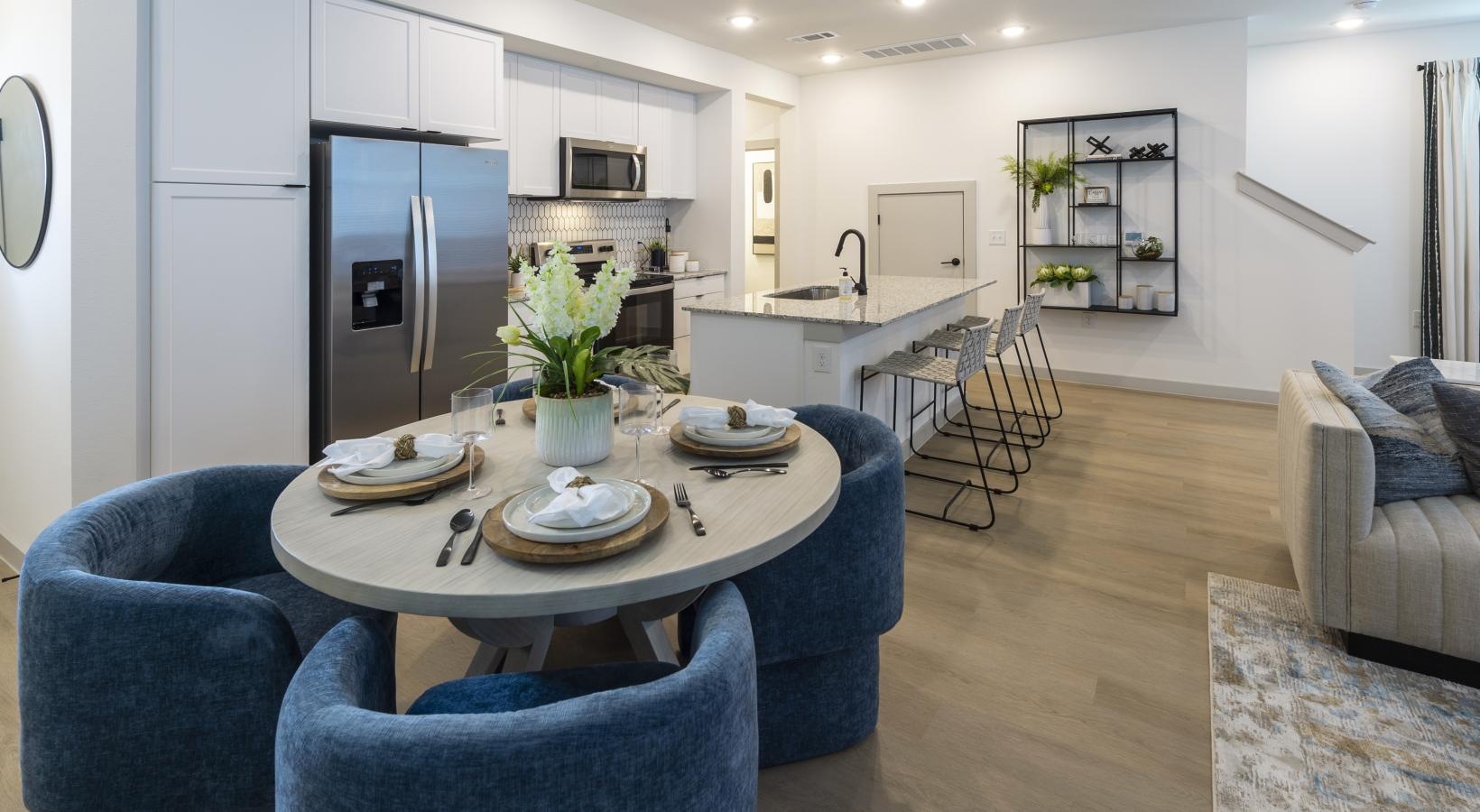 Settle into comfort at Inspire Missouri City a kitchen with a dining table