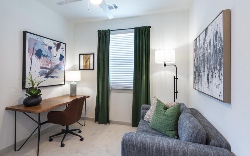 a room with a desk and a couch