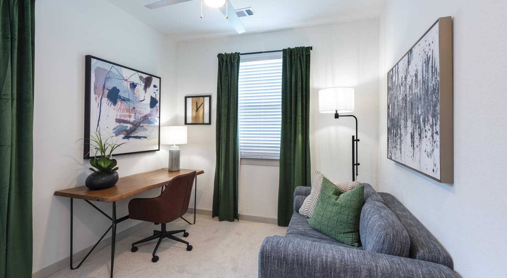 Refined spaces to match your style a room with a desk and a couch