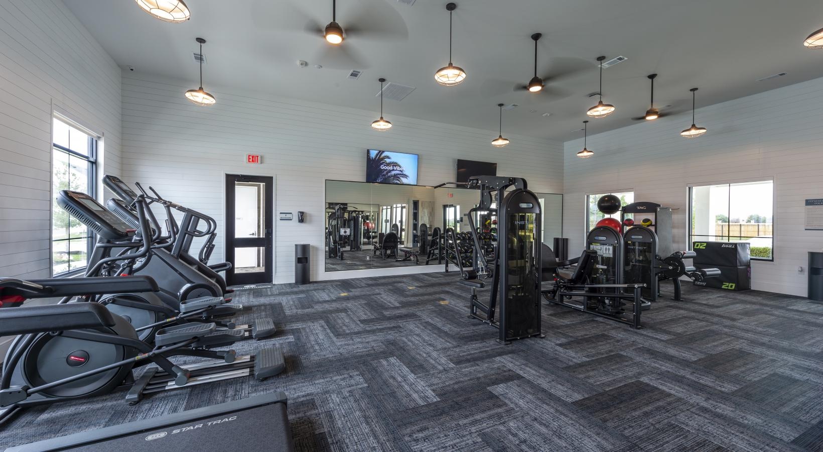 Settle into comfort at Inspire Missouri City a gym with treadmills
