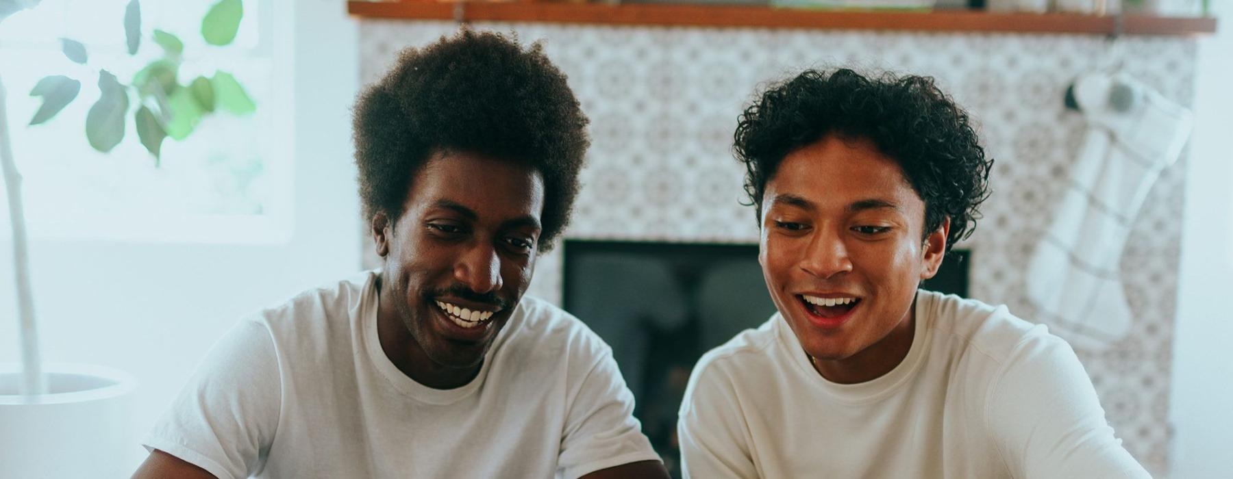 father and son sit together in living room