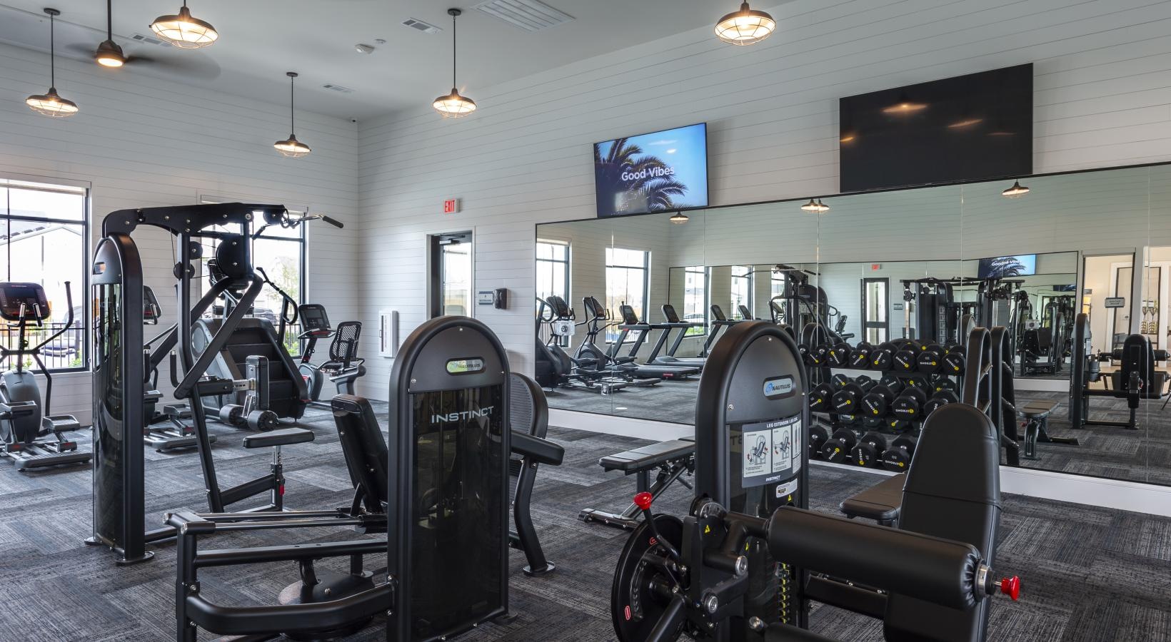 Settle into comfort at Inspire Missouri City a gym with exercise equipment
