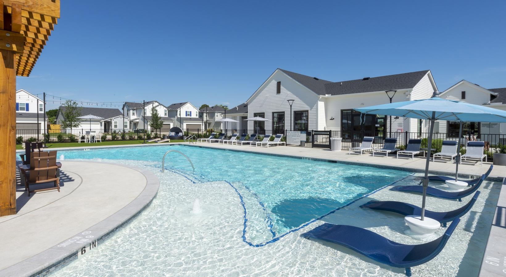 Shimmering resort-style pool a swimming pool with a lounge chair
