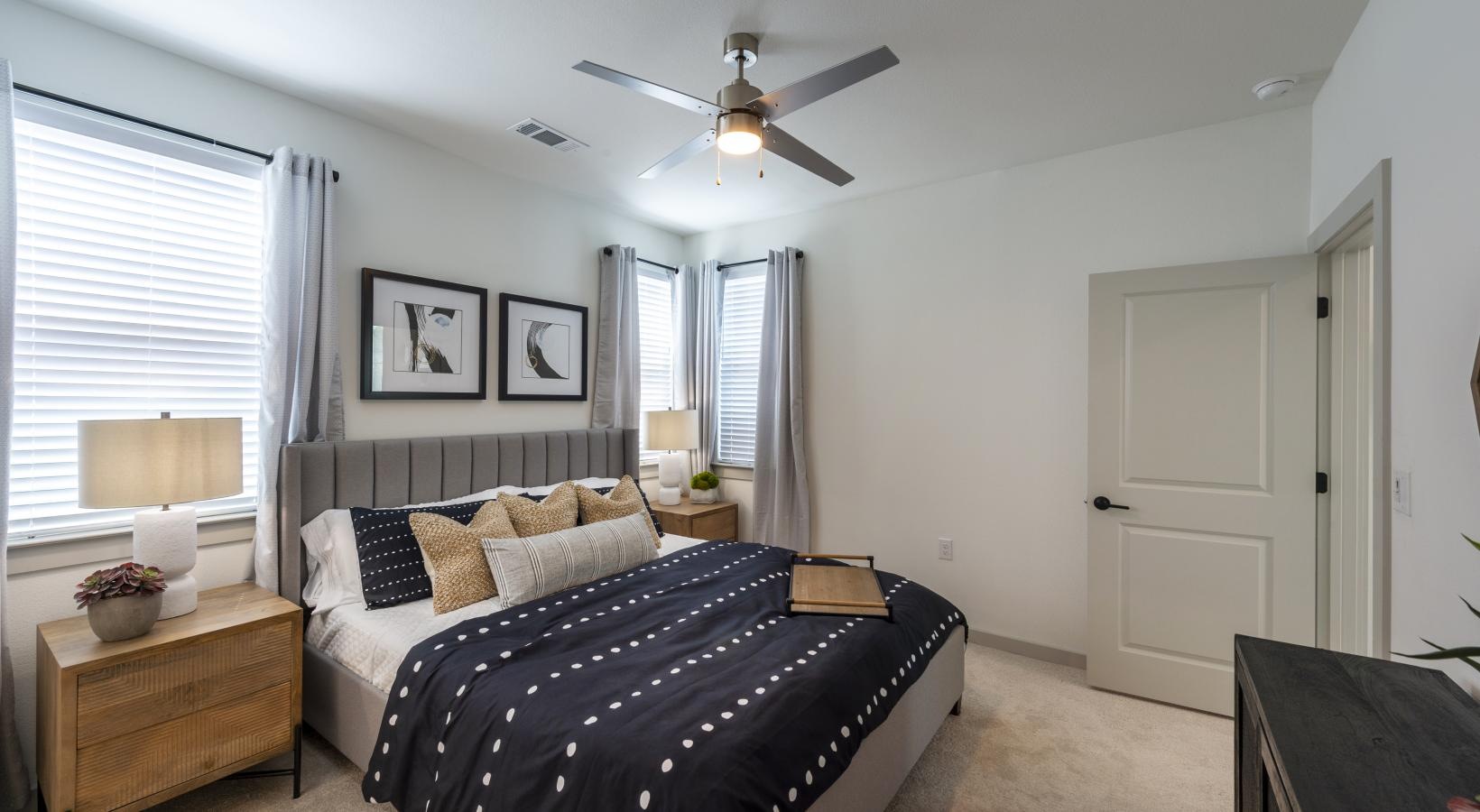 Beautiful bedrooms to fit every need a bedroom with a bed and a fan