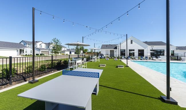 Find your perfect fit at Inspire Missouri City a pool with chairs and tables by it